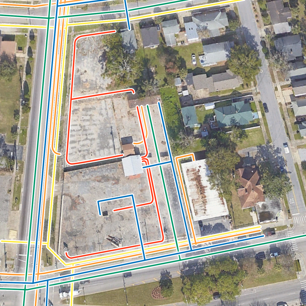 Aerial image of an old gas station with a GIS utility map overlay in Pensacola, Florida.